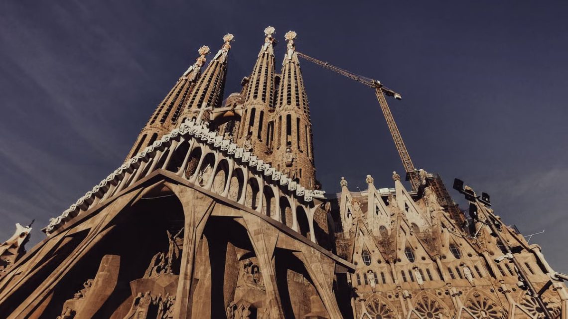 Stunning low-angle shot of La Sagrada Familia in Barcelona under a clear sky.